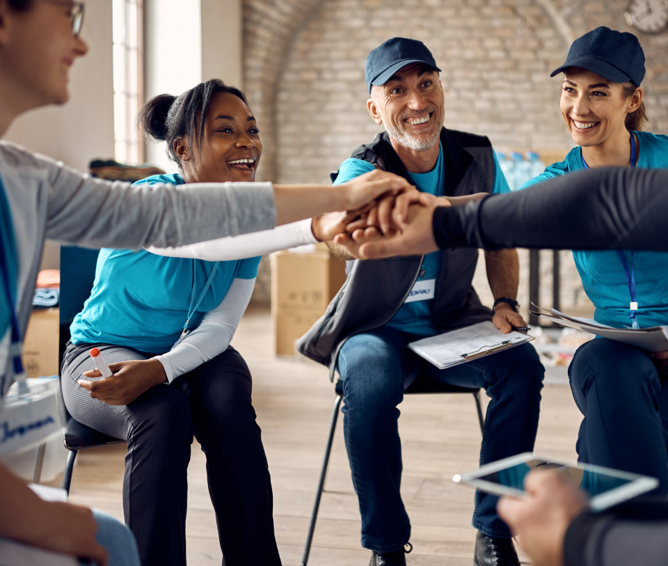 Group of people in teamwork huddle.