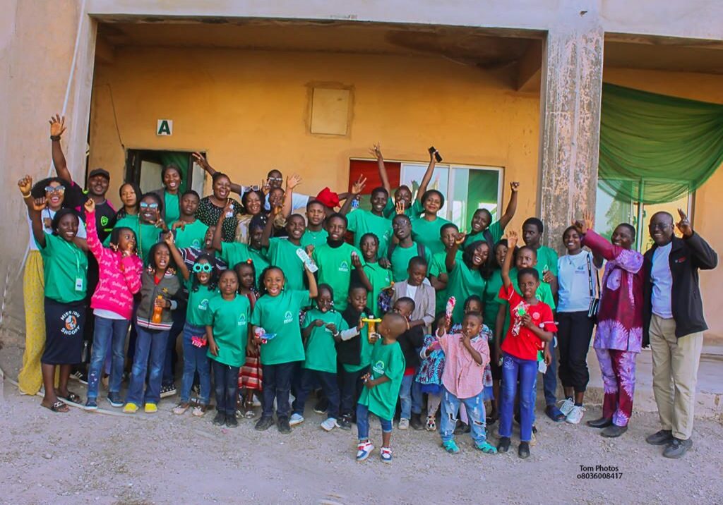 Group of people in green shirts celebrating.